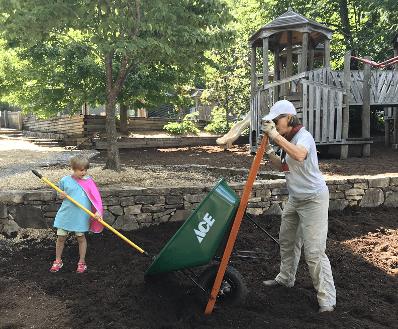 Two volunteers spreading mulch in Robert Lake Park.