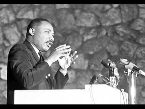 Martin Luther King Jr. speaking on stage in Anderson Auditorium.