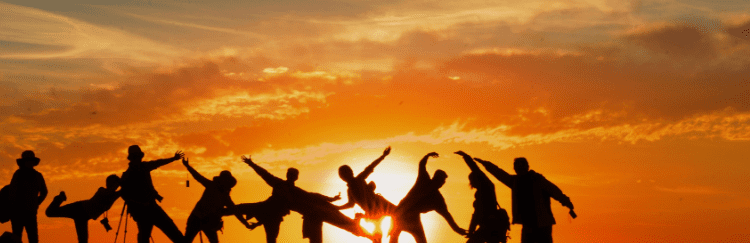 People's shadows in front of a sunset.