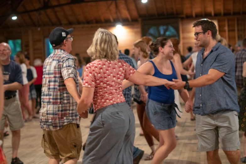 Adults dancing during the Big Circle Mountain Dance in the Barn.