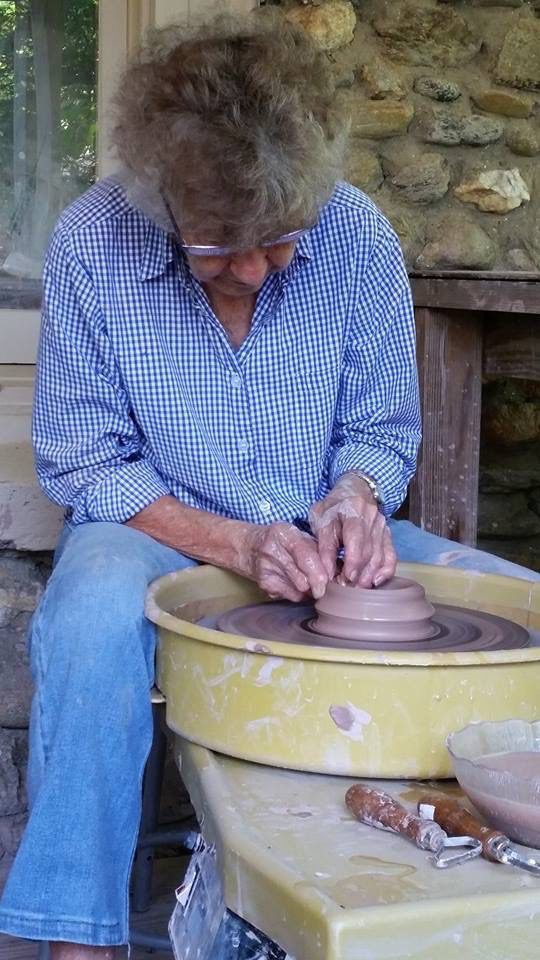 Elderly woman throwing a vase at the Currie Craft Center.